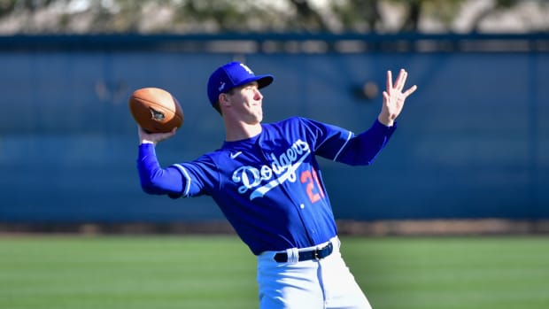 Feb 18, 2020; Glendale, Arizona, USA; Los Angeles Dodgers starting pitcher Walker Buehler (21) throws a football during a spring training workout at Camelback Ranch. Mandatory Credit: Matt Kartozian-USA TODAY Sports